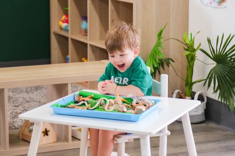 A young child exploring a sensory tray at Expeditions Avoca