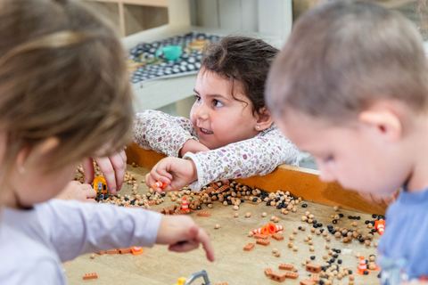 Children investigating materials at a shared table at Expeditions Avoca