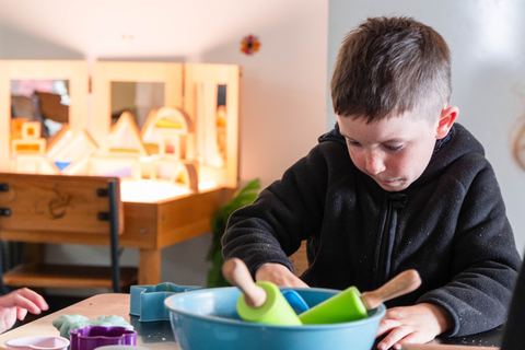 A child using utensils in a sensory activity at Expeditions Avoca