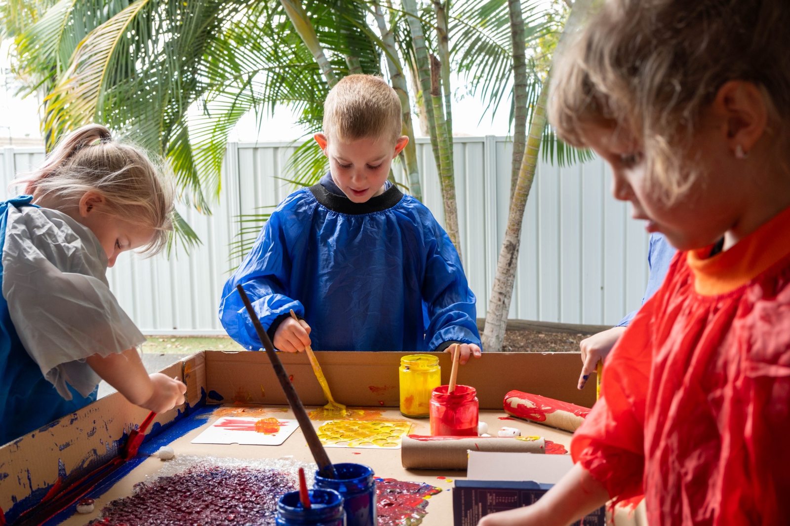 Children painting together at a table at Expeditions Avoca