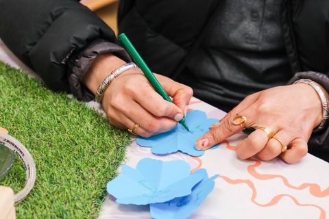 An adult preparing a creative learning activity at Expeditions Narre Warren