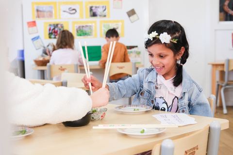 A child exploring a creative table activity at Expeditions Narre Warren