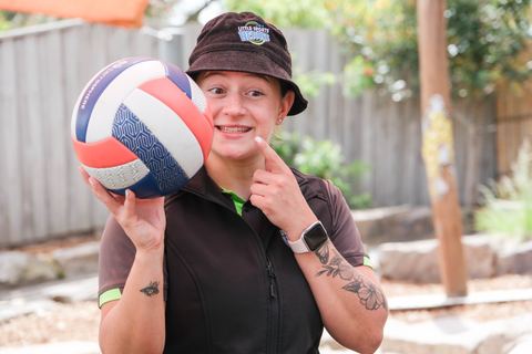 An adult holding a ball outdoors at Expeditions Narre Warren