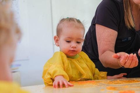 A young child exploring a tabletop sensory activity at Expeditions Raceview