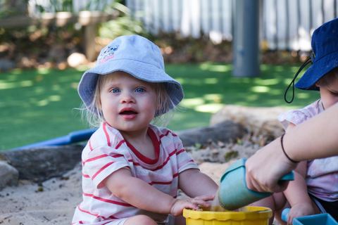 A young child exploring the sandpit at Expeditions Raceview