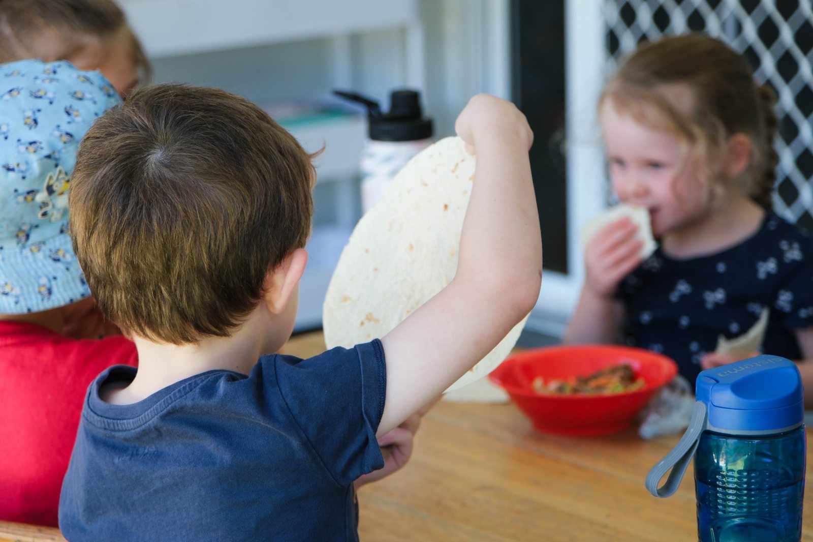 Children enjoying a shared meal at Expeditions Raceview
