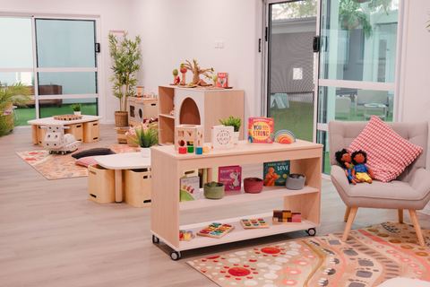 Child-height shelves, books and a reading chair at Expeditions Raceview 2