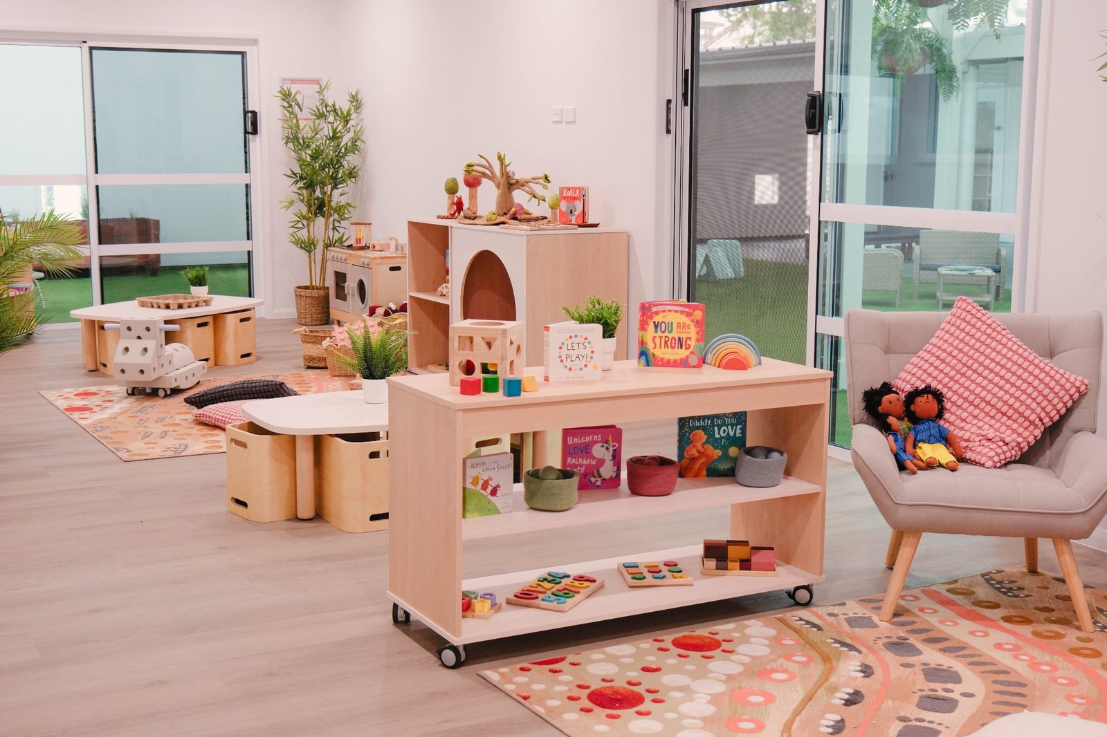 Child-height shelves, books and a reading chair at Expeditions Raceview 2