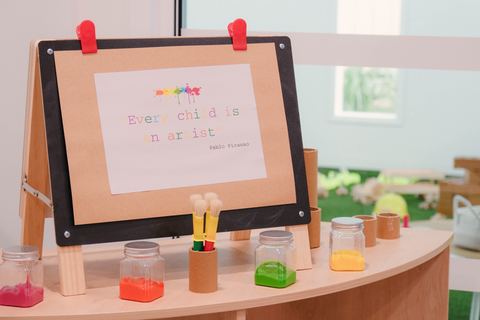 Paint pots and a tabletop art invitation at Expeditions Raceview 2