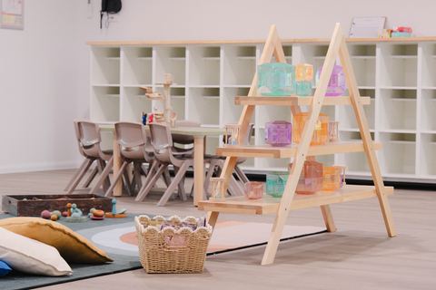 Art shelves, cushions and a shared table at Expeditions Raceview 2