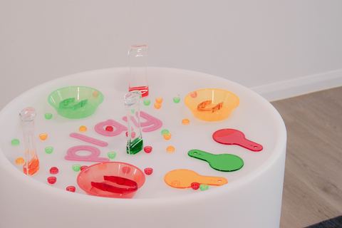 A circular table with colourful play materials at Expeditions Raceview 2