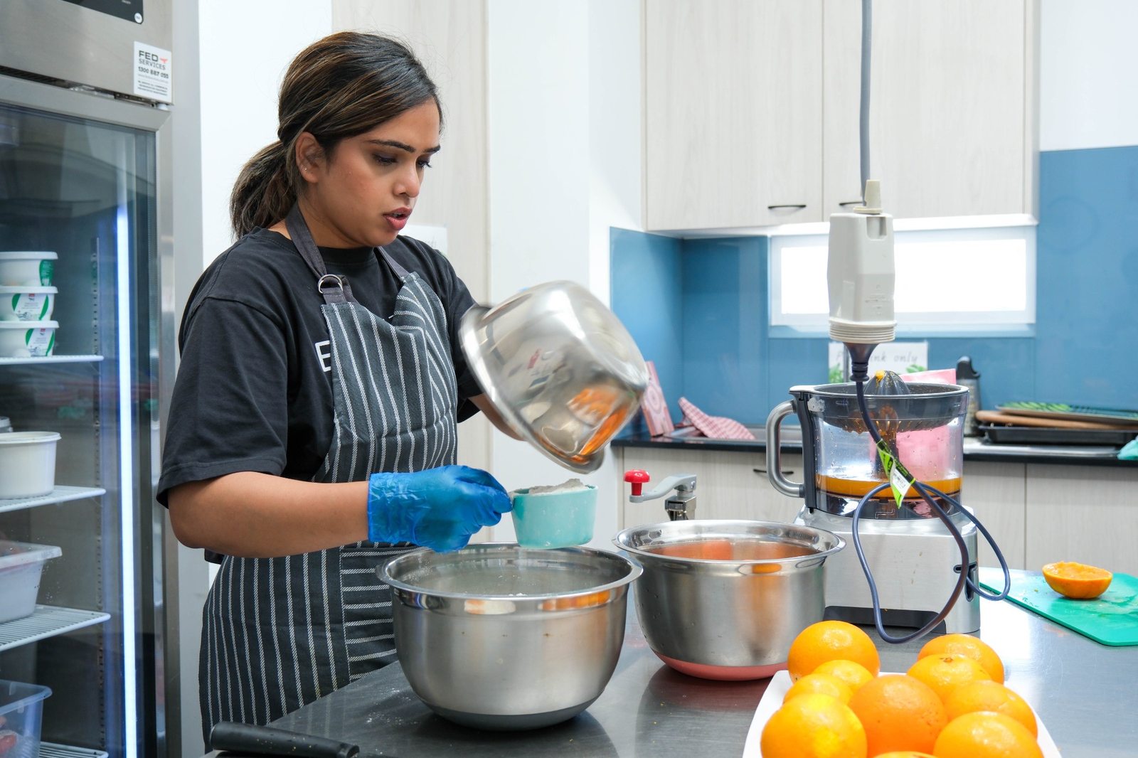 A chef preparing food in the centre kitchen at Expeditions Underwood