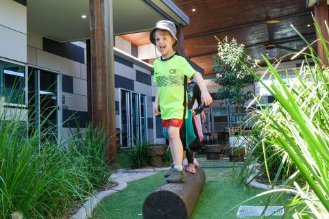 A child balancing on an outdoor log at Expeditions Underwood