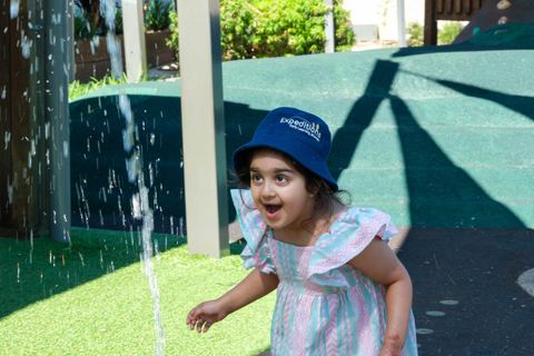 A child exploring the outdoor water play area at Expeditions Underwood