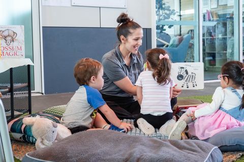 An educator sharing a story with children at Expeditions Underwood