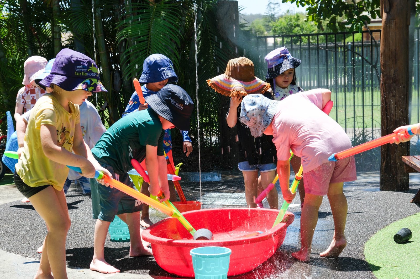 Children enjoying outdoor water play at Expeditions Raceview